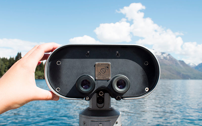 Binoculars looking out on a lake