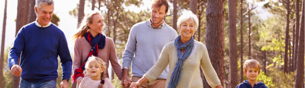 A multi-generational family walking through the countryside.