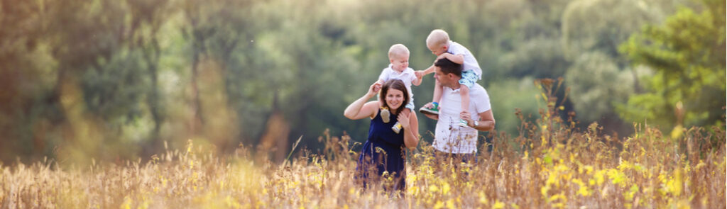A family walking through a field in spring time.