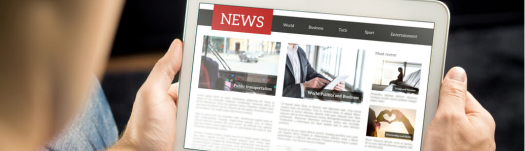 A man reading the news on a tablet.