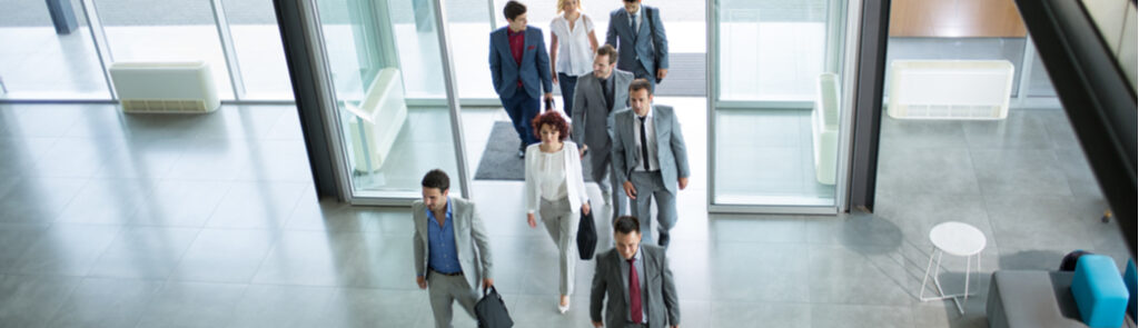 Business people walking into an office building.