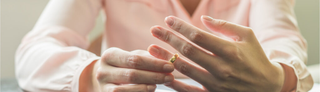 A woman removing her wedding ring.