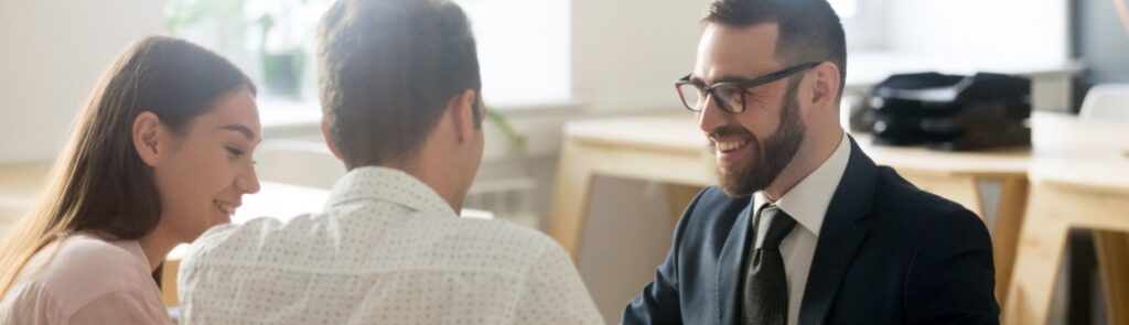 A young couple meeting with a financial planner.