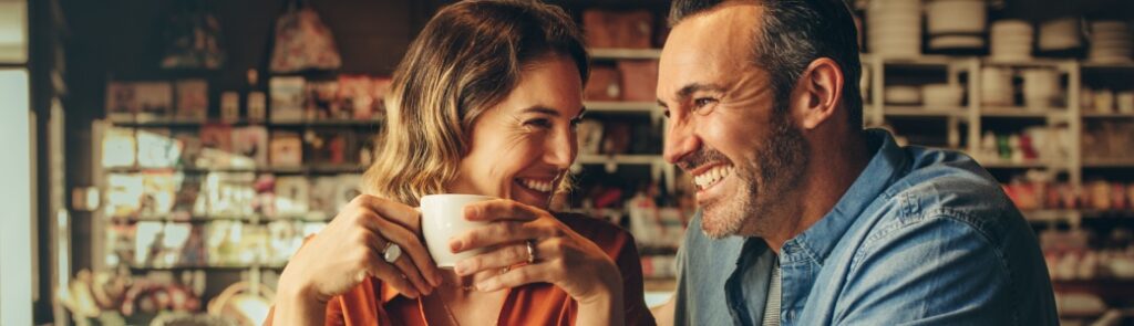 A couple laughing in a café.