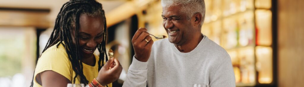 A couple laughing together at a café.