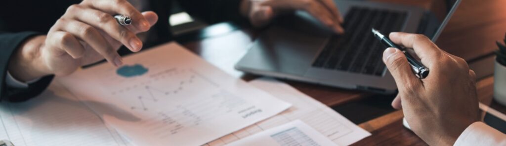Two people analysing statistical reports.