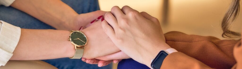 Two people clasping hands.