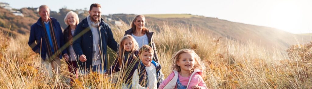 A family walking through dunes.