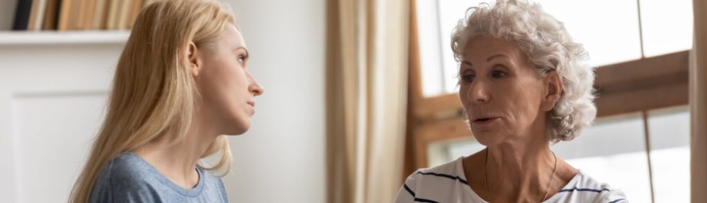 A mother and adult daughter talking.