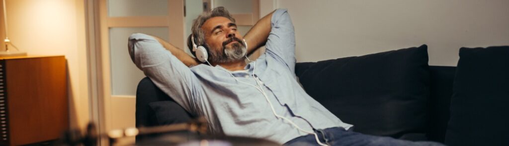 A man relaxing while listening to music.