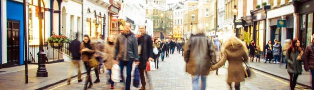 People walking down a high street.