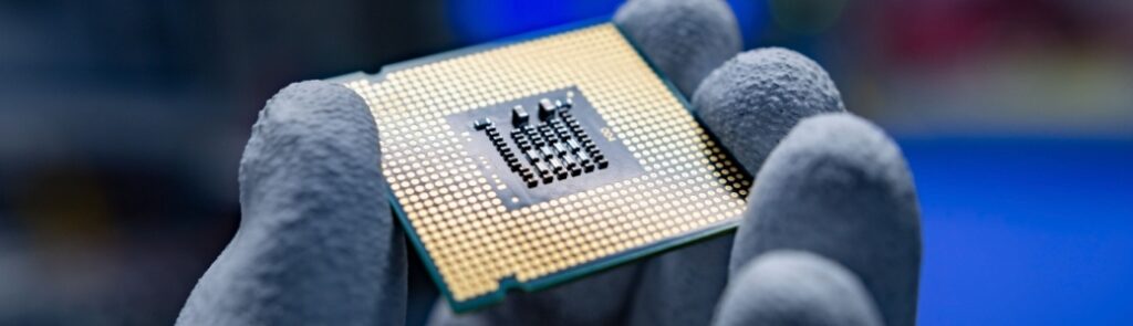 A hand holding a CPU.