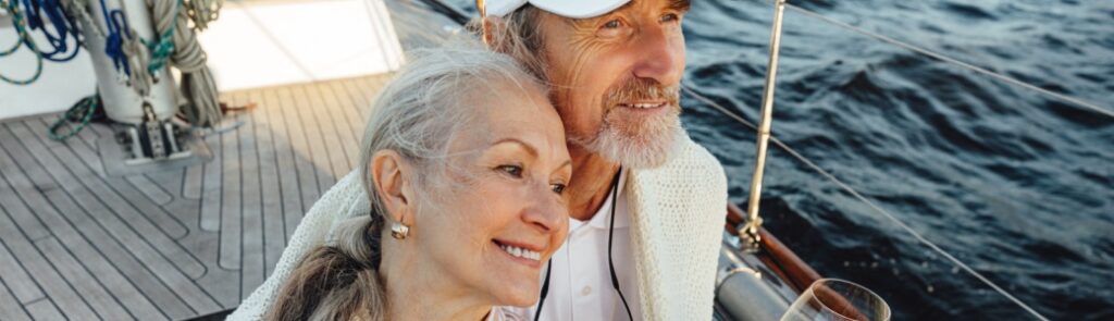 A couple sitting on a yacht deck.
