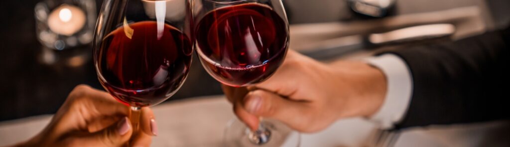 A couple toasting with wine glasses.