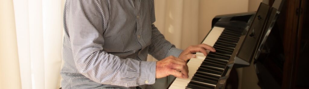 A man practising playing the piano.