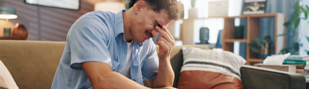 A stressed man with his head in its hand.