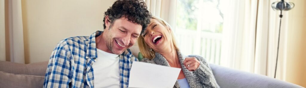 A happy couple reviewing paperwork.