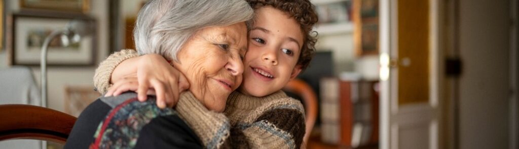 A woman hugging her grandchild.