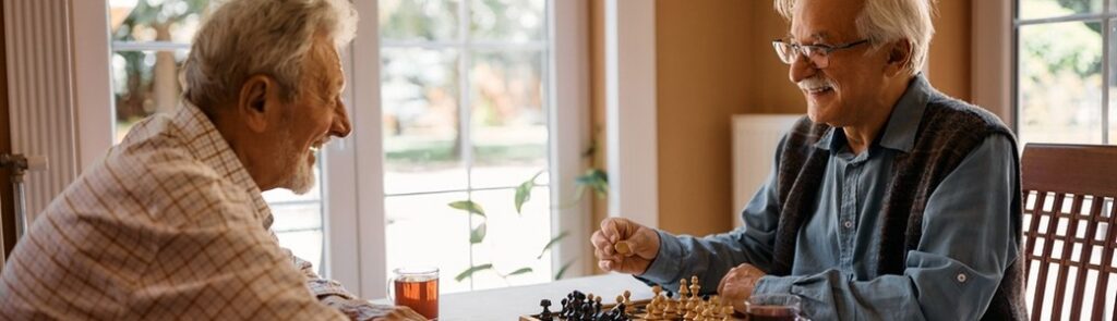Two men playing chess at home.