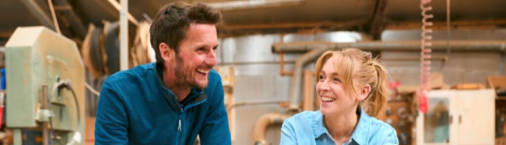 Two people in a woodwork workshop.