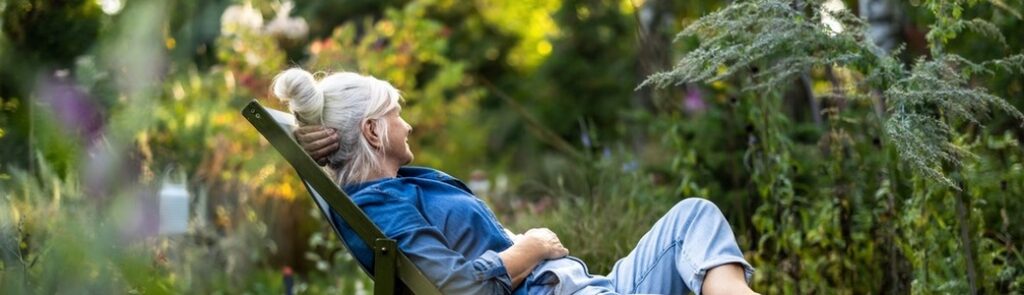 A woman relaxing in a garden.
