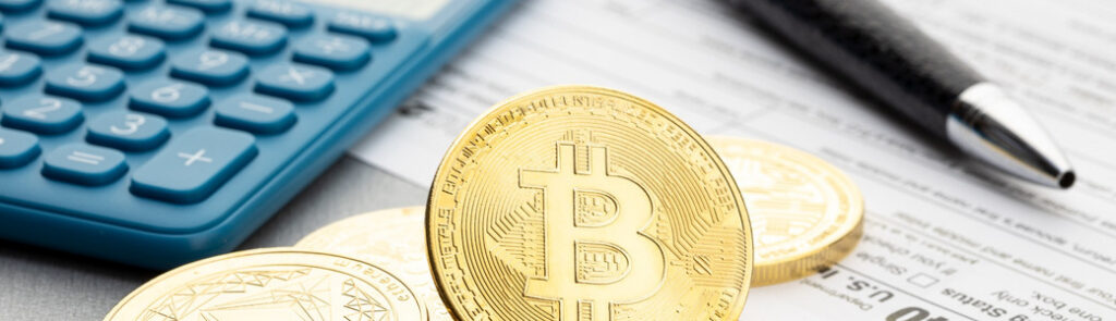 A representation of cryptocurrency next to a calculator.