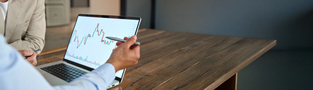 A man reviewing stock market movements on a laptop.